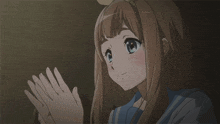 a girl with long brown hair and blue eyes is looking down