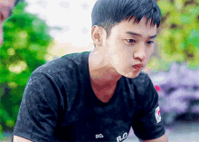 a young man wearing a black t-shirt with the word ro on it
