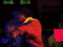 a blurry picture of a person in a dark room with a green light behind them