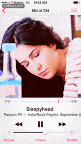 a woman is sleeping while listening to sleepyhead on a cell phone
