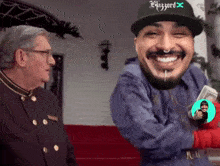 a man wearing a hat that says blizzard is smiling and holding money