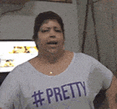 a woman wearing a white shirt that says # pretty