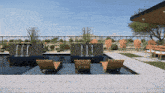 a swimming pool with a fence surrounding it and chairs in front of it