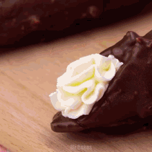 a close up of a chocolate dessert with whipped cream and the words mr cakes below it