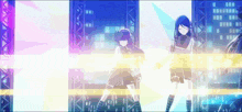 two anime girls are dancing on a stage in front of a building .