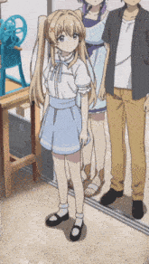 a girl in a blue skirt is standing next to a man and another girl