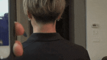 a close up of a person 's back with a very short haircut .