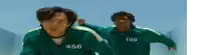 two men in green jackets with the numbers 456 and 199 on them are running in a race .