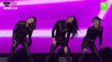 a group of young women are dancing on a stage .