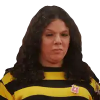 a woman wearing a yellow and black striped shirt has a pin with the number 3