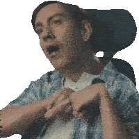 a man in a blue plaid shirt is sitting in a chair