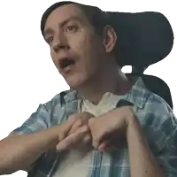 a man in a blue plaid shirt is sitting in a chair