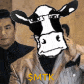 a man in a suit has a cow 's head on his shoulder and the words $ mtk written on it