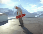 a man is holding a red skateboard with the letters e on it