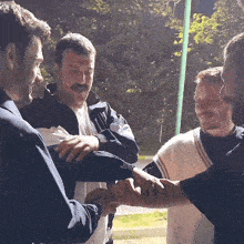 a group of men are shaking hands with a caption that says ' ncrmdlmoons ' at the bottom