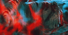 a close up of a person 's face with red smoke coming out of it .