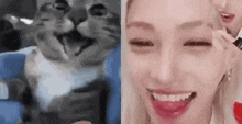 a woman is smiling next to a cat that is looking at the camera .