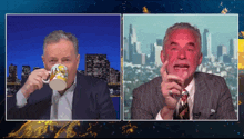 a man in a suit is drinking from a mug that says california