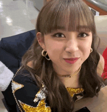 a close up of a woman wearing earrings and a choker that says ' a ' on it