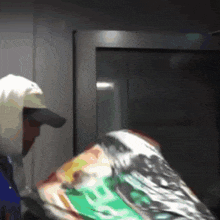 a man in a white hoodie is holding a bag that says coca cola