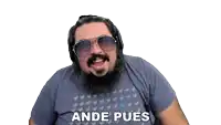 a man with a beard and sunglasses is wearing headphones