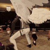 a person with white wings is standing in a room with a sign that says ' aspa_of lever 18 ' on it