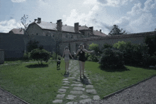 Inge And Heideraud Are Walking In The Garden Wearing Swimsuits The Zone Of Interest GIF - Inge And Heideraud Are Walking In The Garden Wearing Swimsuits The Zone Of Interest The Zone Of Interest Film GIFs