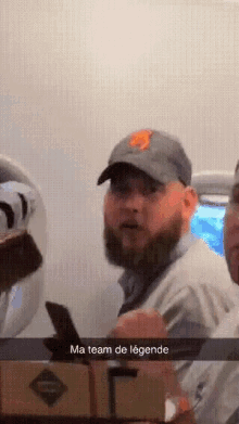 a man with a beard is wearing a hat that says ny on it