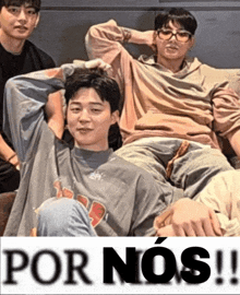 a group of young men laying on a couch with the words por nos written on the top
