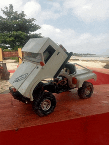 a toy truck with the hood up and a bfgoodrich tire