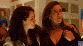 two women standing next to each other with bbc america written on the bottom left