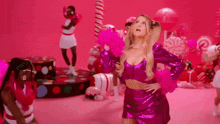 a woman in a pink dress is standing in front of a pink background