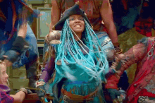 a woman with blue braids is wearing a pirate hat and holding a sword