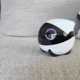 a black and white robot is sitting on a couch .