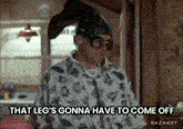 a man wearing a fish shirt and goggles says that leg 's gonna have to come off