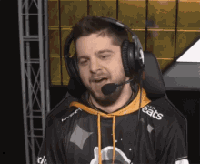 a man wearing headphones and a shirt that says cats