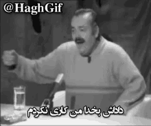 a black and white photo of a man in front of a microphone with a caption that says " @haggif "