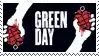 a green day logo with two hands holding a grenade