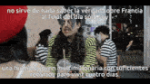 a group of people are sitting at a table and one of them is wearing a striped shirt