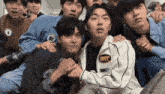 a group of young men are posing for a picture with one wearing a jacket with the number 8r on it