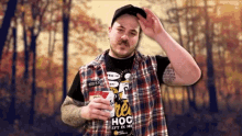 a man wearing a plaid shirt that says " re hoc " on it