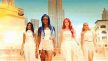 a group of women in white dresses are standing in front of a city skyline