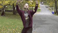 a man wearing a t-shirt that says it 's my way is jumping in the air