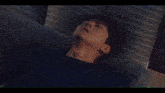 a close up of a person laying on a bed
