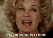 a woman with a surprised look on her face is asking how can you still be so blind