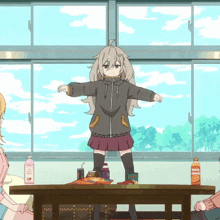 a girl standing on a table with a bottle of orange juice