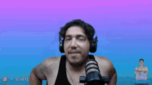 a man wearing headphones is waving his hands in front of a microphone