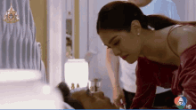 a woman laying on a man 's face with the number 7 on the bottom