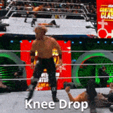 a knee drop is being performed by a wrestler in a ring
