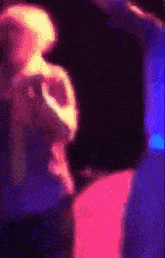 a blurry image of a person dancing in a dark room
